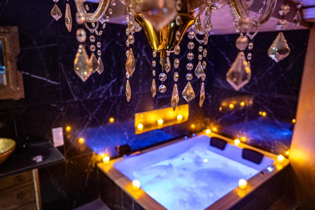 a jacuzzi tub in a room with lights at Suite Romantique in Narbonne