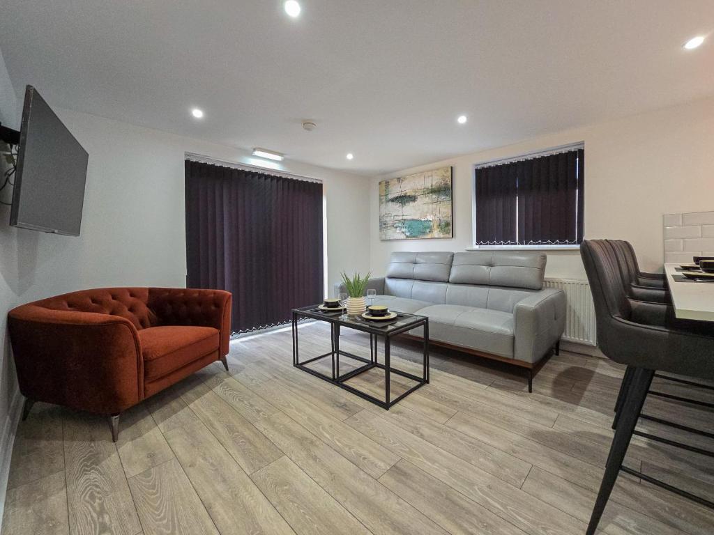 a living room with a couch and a table at DYSA Bond Apartments in Blackpool