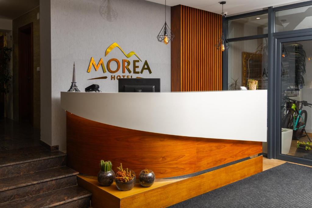 a morea hotel lobby with a white and wooden counter at Morea Hotel in Prizren