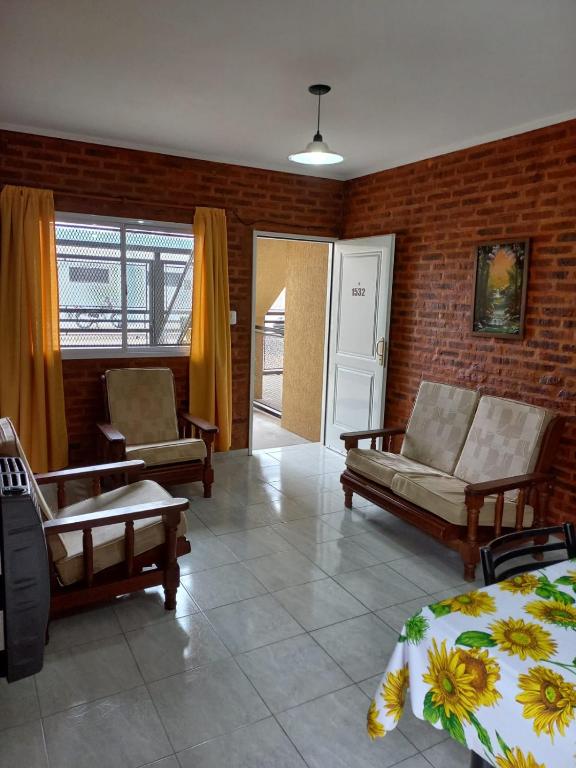 a living room with a bed and a couch and chairs at 4 Estaciones in Pergamino