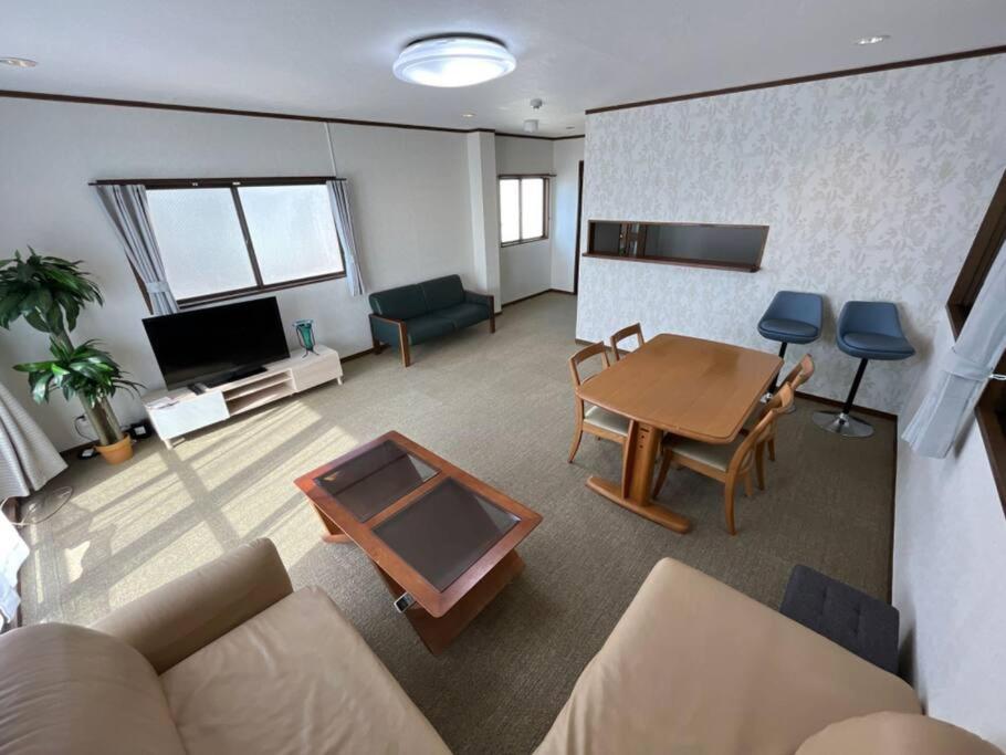 a living room with a couch and a table at N's Home - 南名古屋駅一軒家ルームシェア-12 in Nagoya