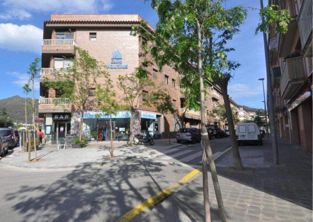 a building on a city street with cars parked at RNET-Nautilus Roses Costa Brava in Roses