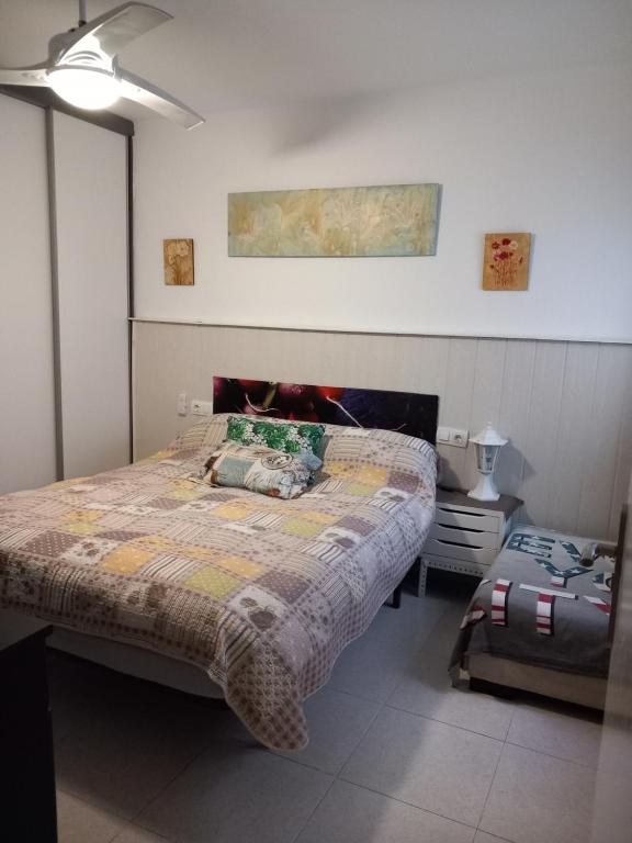 a bedroom with a large bed and a night stand at Castellón in Castellón de la Plana
