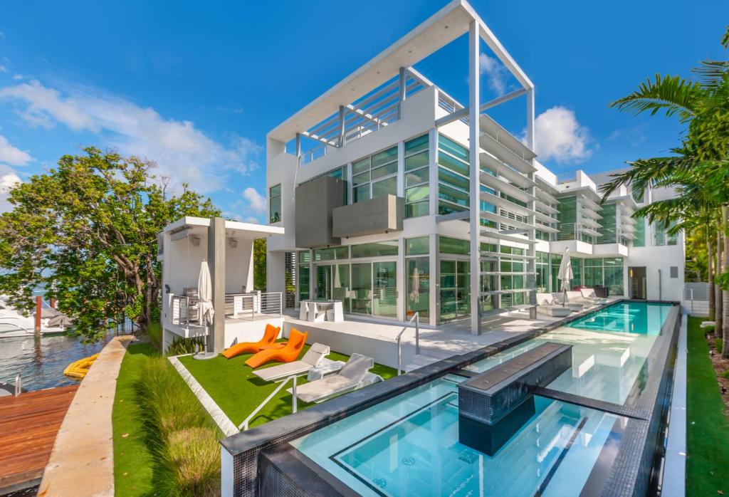 a large white house with a swimming pool at Indulge in Waterfront Elegance Your Ultra Luxury Miami Beach Estate Beckons! in Miami