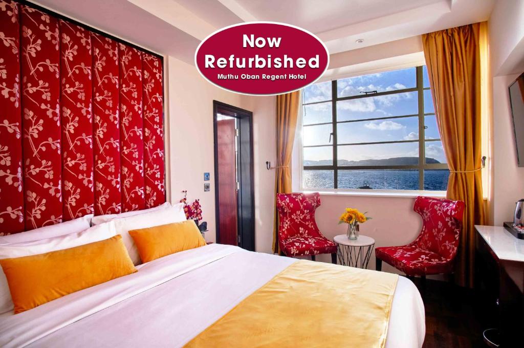 a hotel room with a bed and two red chairs at Muthu Oban Regent Hotel- Refurbished in Oban