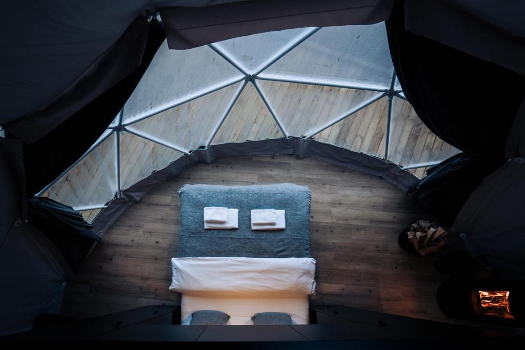 an overhead view of a room in a tent with a bench at Golden Circle Domes - Lake View in Selfoss