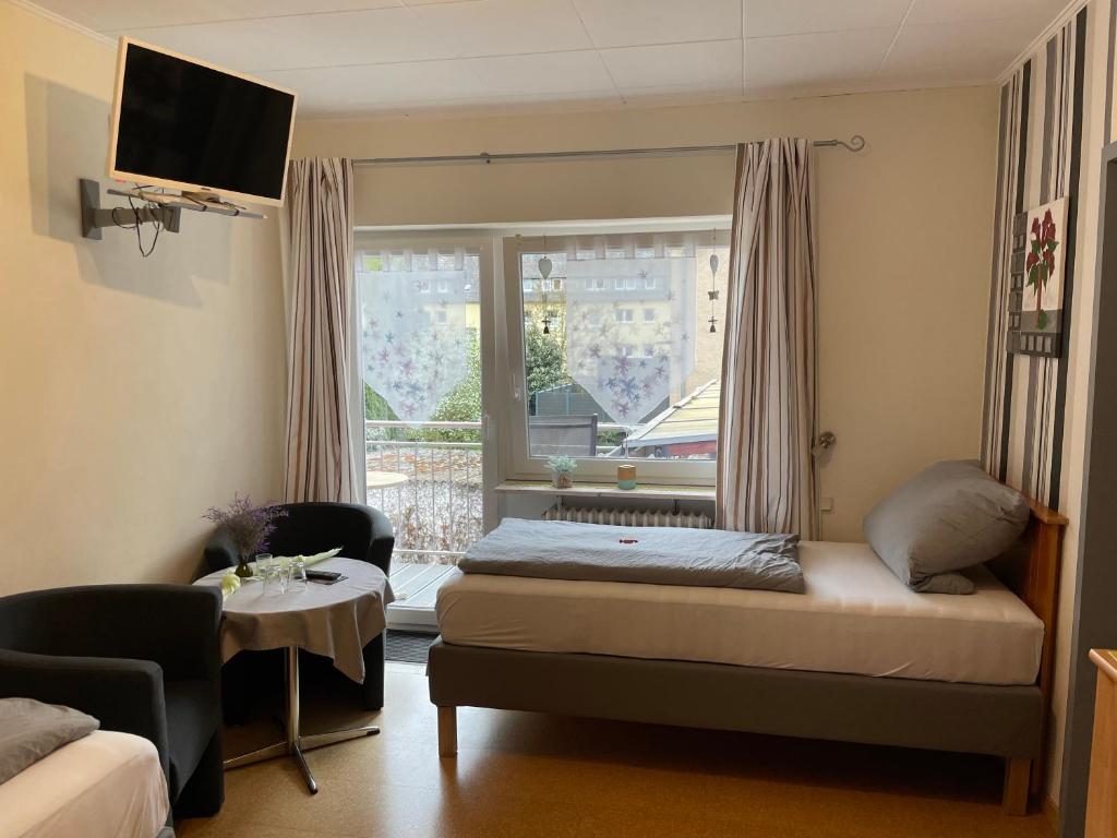a small bedroom with a bed and a window at Pension Bartz in Traben-Trarbach