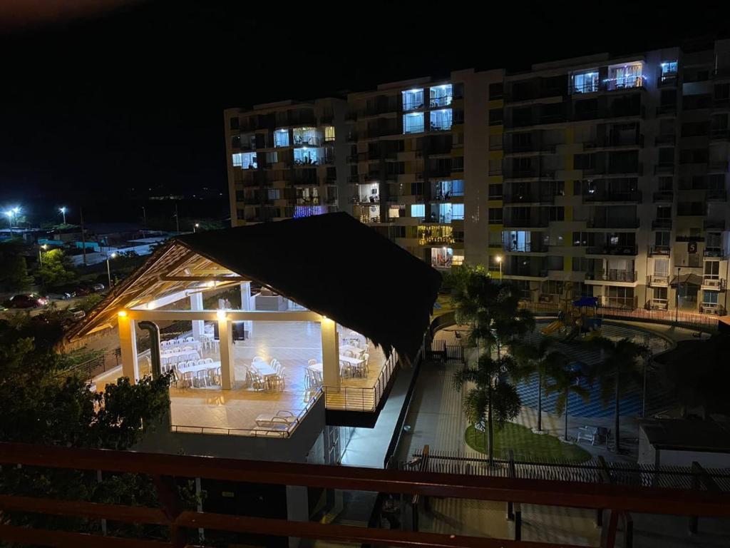 a building with a gazebo on a balcony at night at Ricaurte Cundinamarca La Aldea - hermosa vista a las piscinas in Ricaurte