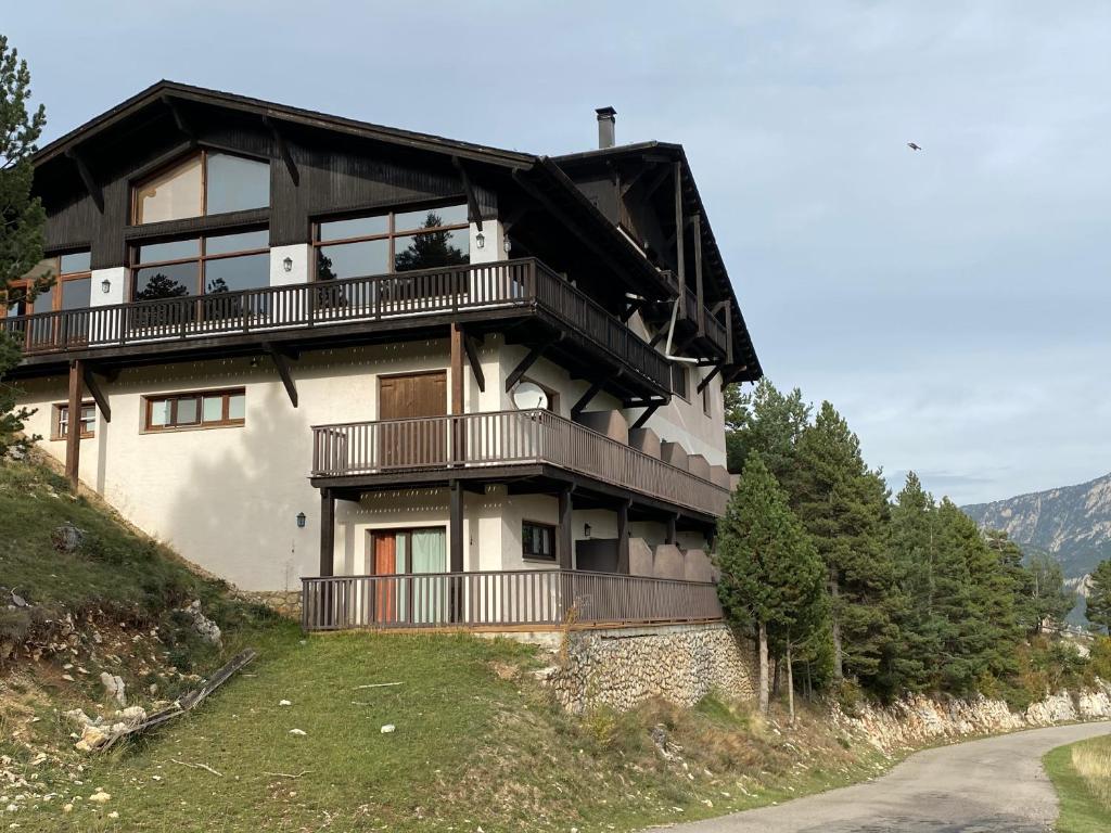 a building with balconies on the side of a hill at Hotel Golf Natura in La Coma i la Pedra