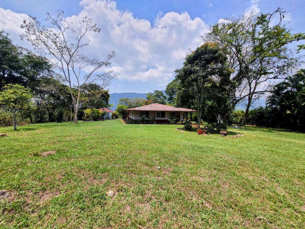 a house in the middle of a grass field at Llanitos de Aurora in Ibagué