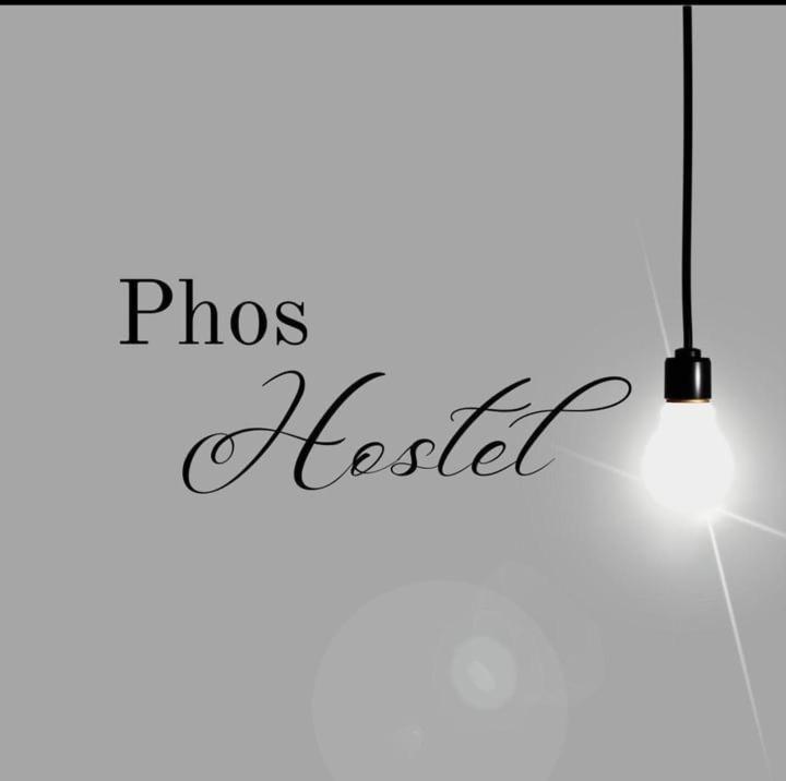 a hanging light with the words phos needle at Phos Hostel in Araxá