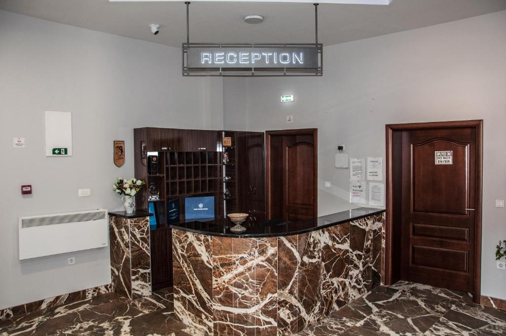 a lobby with a reception desk in a building at Hotel Mountain View Inn in Gusinje