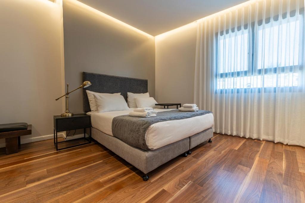 Postel nebo postele na pokoji v ubytování Hematian Hotel by Effy