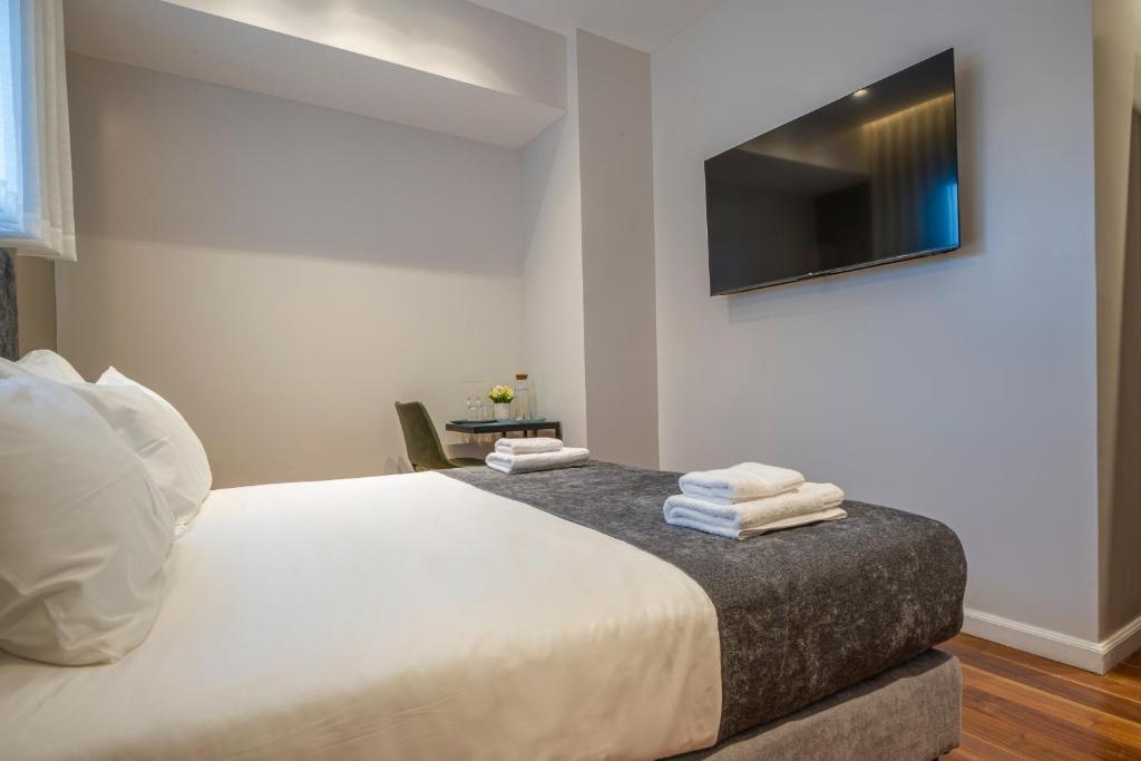Postel nebo postele na pokoji v ubytování Hematian Hotel by Effy