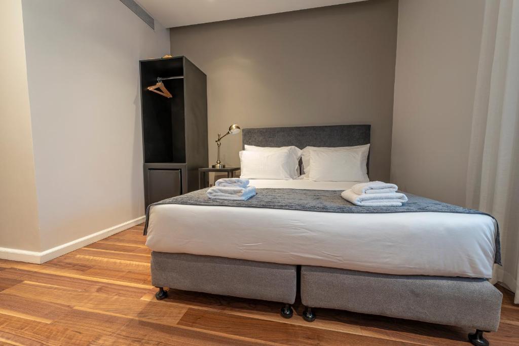 Postel nebo postele na pokoji v ubytování Hematian Hotel by Effy