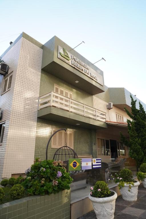 a building with a sign on the side of it at Pousada Brisa do Mar in Torres