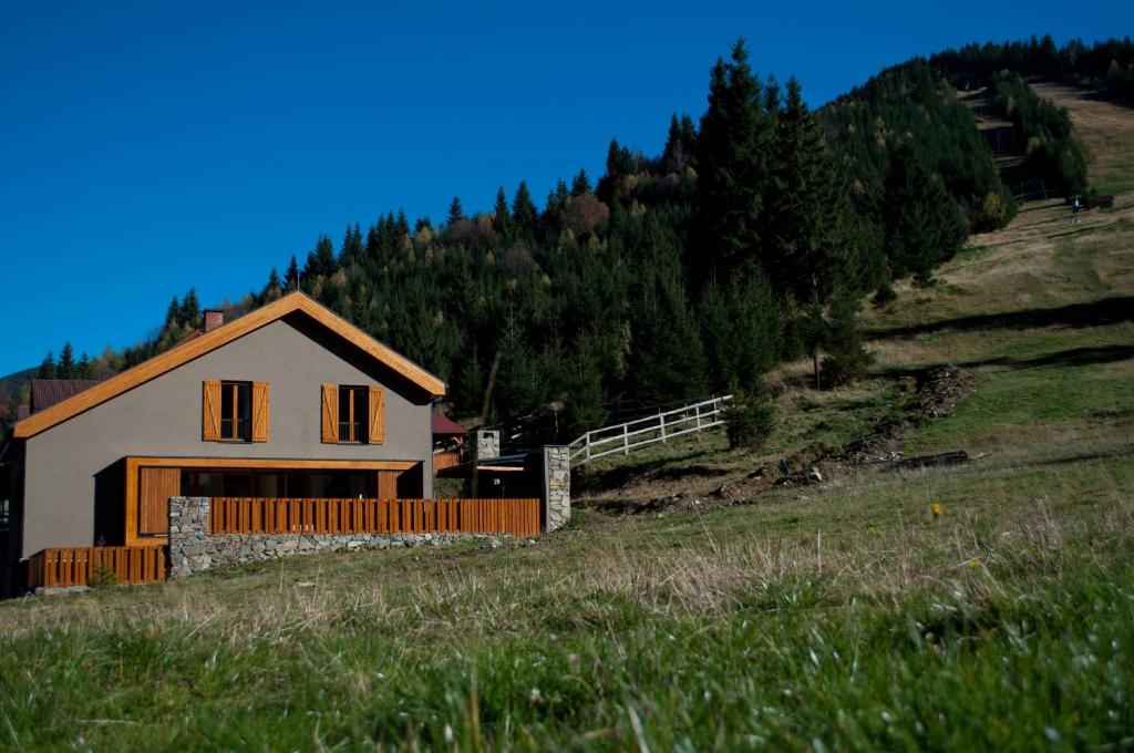 a house on the side of a hill at Cabana Poarta Retezat in Rîu de Mori