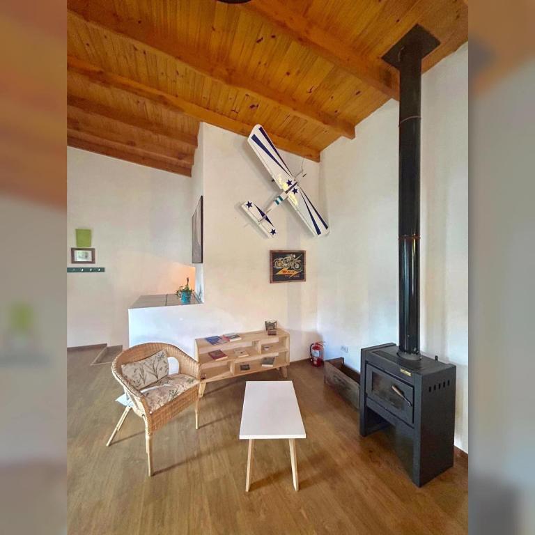 a living room with a wood stove and a bed at Buddha Tempo in Esquel