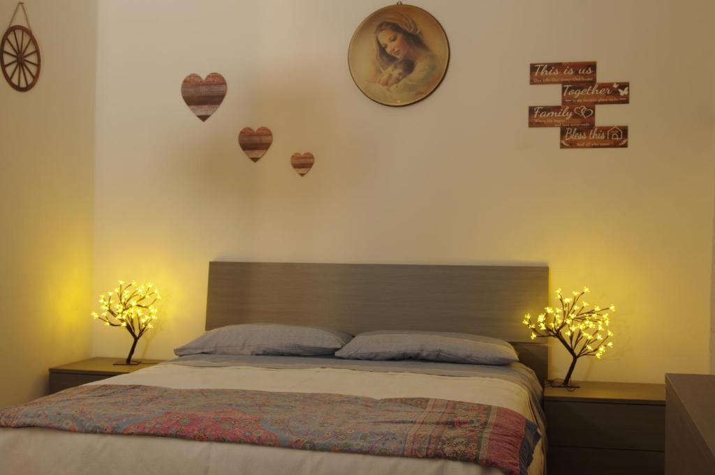 Gianni's beautiful house in the mountains في Lama dei Peligni: غرفة نوم بسرير مع مصباحين وساعة