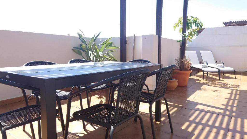 a blue table and chairs on a patio at Apartamento Millón - Private roof terrace with Jacuzzi in Nerja