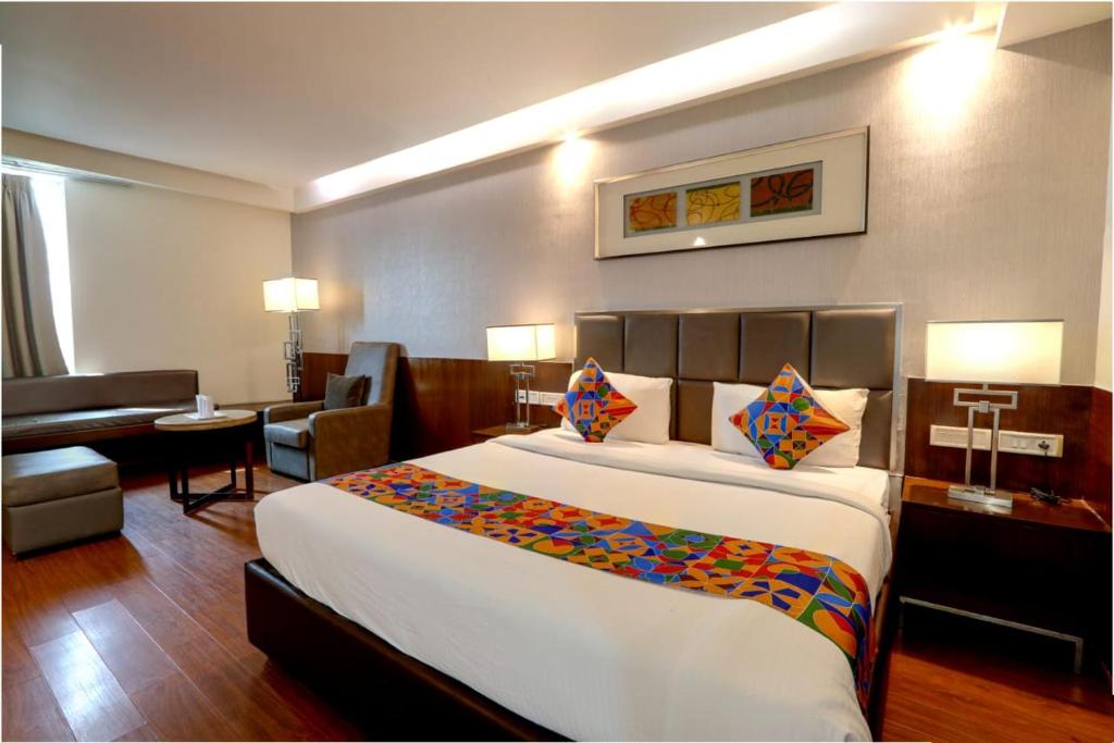 a hotel room with a large bed and a living room at Hotel Care Holiday Banjara- a Luxury Collection Hotel- An Svm Hotel in Hyderabad
