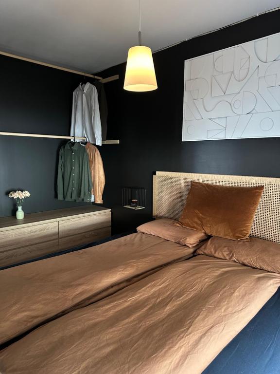 a bedroom with a bed and a black wall at A Place To Stay Stavanger, apartment 4 in Stavanger