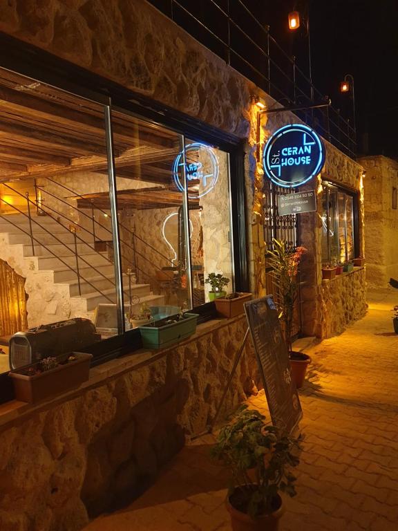 a restaurant with a sign on the side of a building at Ceran Stone House in Nevsehir