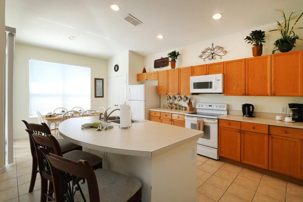 a kitchen with a table and chairs in a room at Luxury 4BD Single-Level Villa with Private Pool - Windsor Palms - Sleeps 8 in Kissimmee