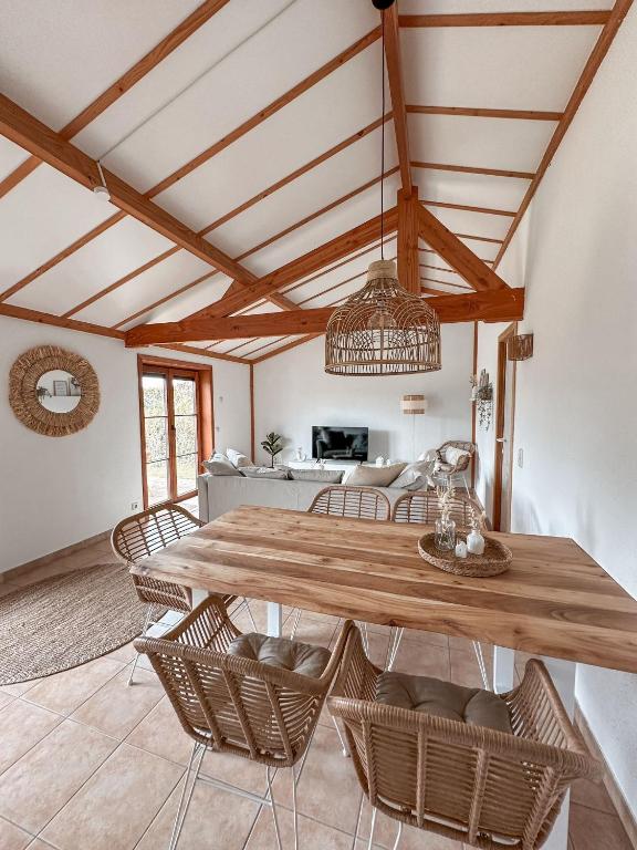 a dining room with a wooden table and chairs at Boho Beach House De Haan in De Haan