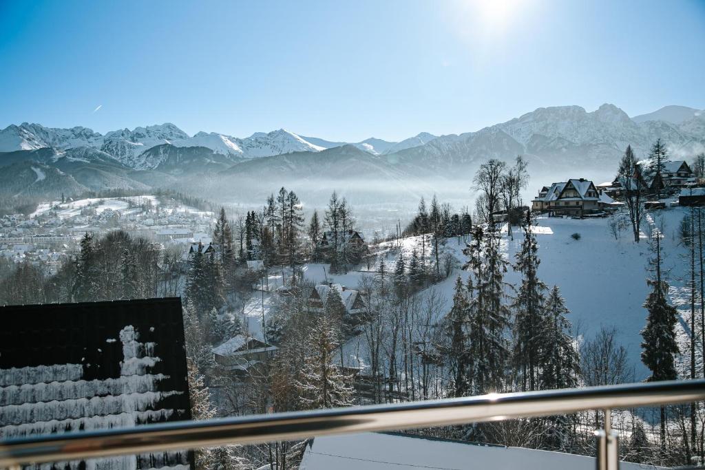 a view of a snow covered valley with mountains at Dom z widokiem na Tatry i Jacuzzi in Zakopane