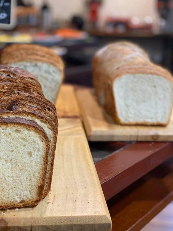 two slices of bread sitting on wooden cutting boards at Hotel Aranjuez in San José