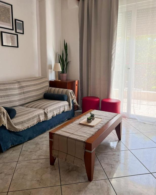 a living room with a couch and a coffee table at Varosi Apartment in Komotini