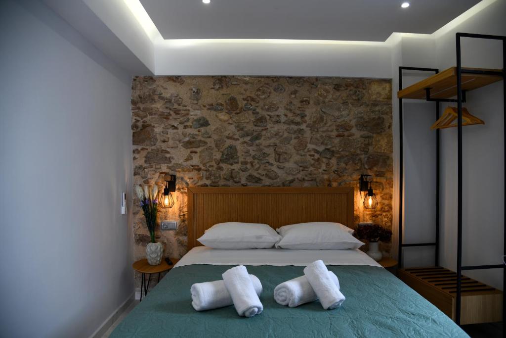 a bedroom with a bed with two towels on it at Authentic Plaka Home in Athens