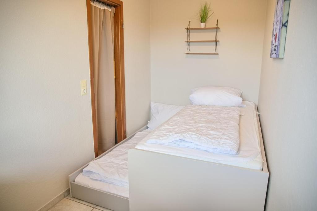 Postel nebo postele na pokoji v ubytování Grömitz- Center II App 18 inkl WLAN
