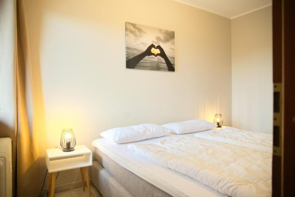 Postel nebo postele na pokoji v ubytování Grömitz- Center II App 18 inkl WLAN