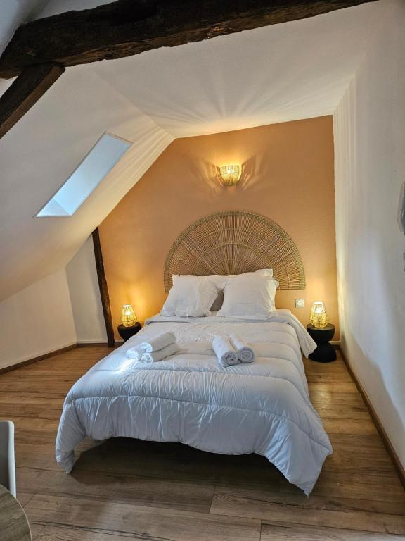 1 dormitorio con 1 cama grande con sábanas blancas en Rêve de Loire en La Daguenière