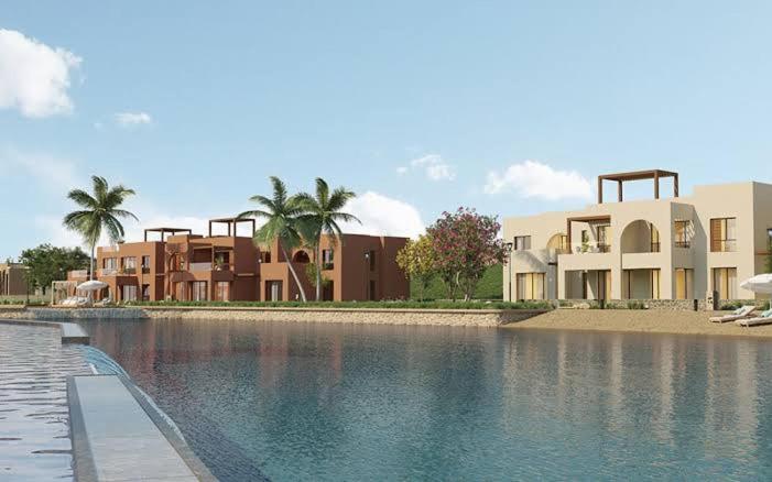 a large pool of water in front of some buildings at Cozy Chalet in Makadi Heights in Hurghada
