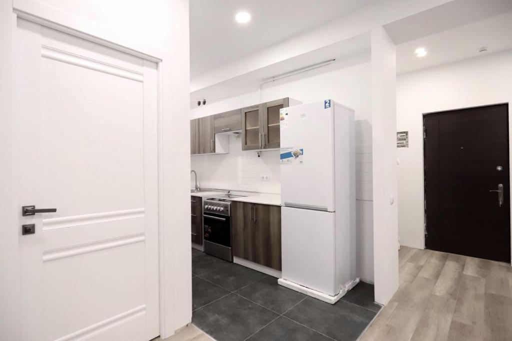 a kitchen with white appliances and a white refrigerator at Kvartira dizaynerskaya in Yerevan