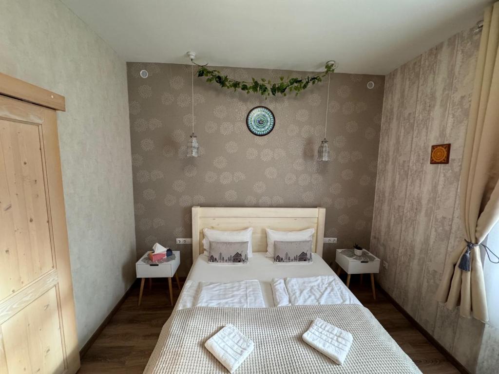 a bedroom with a bed with two pillows on it at Safit-Mandala in Mosonmagyaróvár