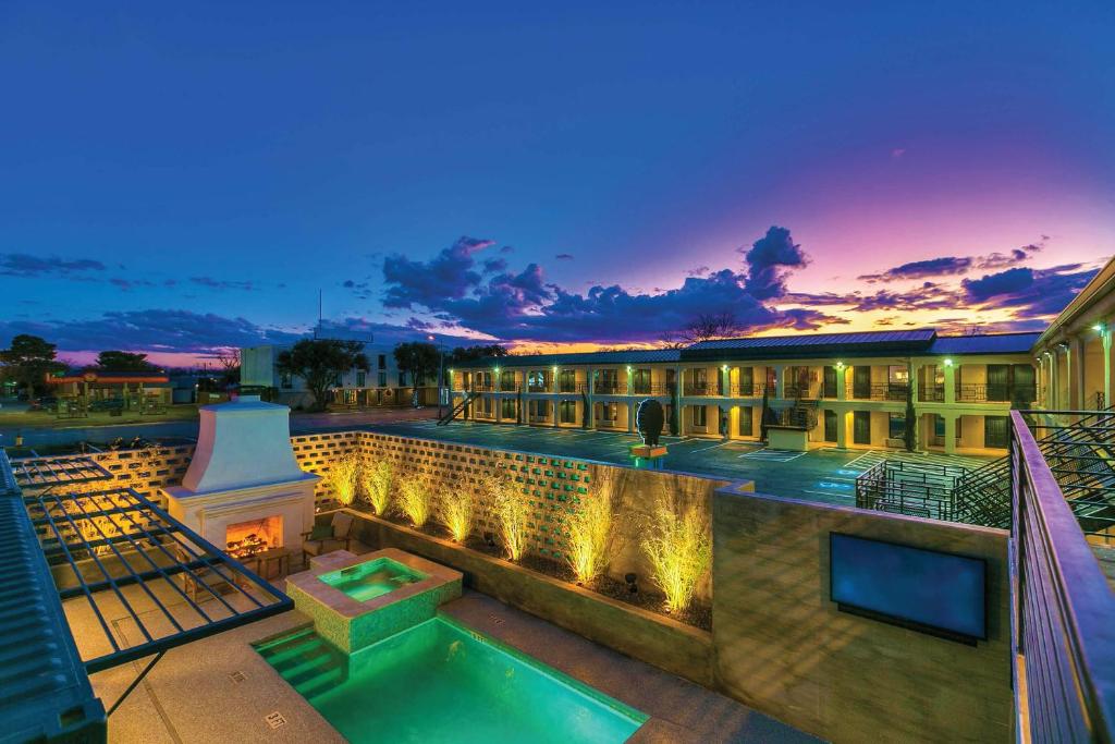 a resort with a swimming pool and a building at Angoria Hotel in San Angelo