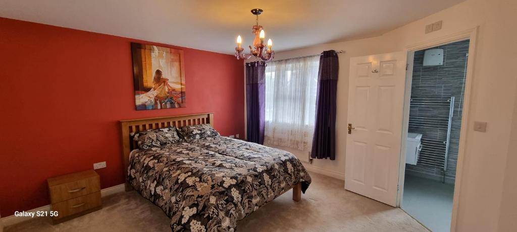 a bedroom with a bed and a painting on the wall at Eden Escape in Ashford