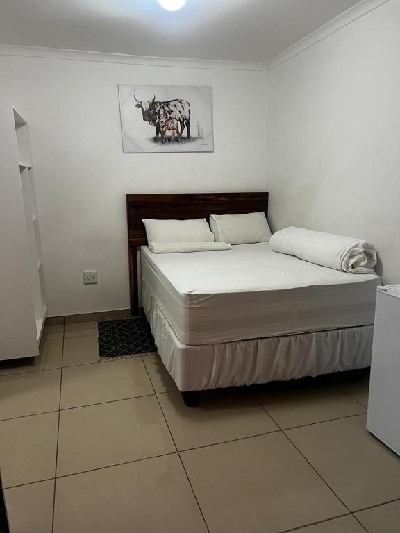 a bedroom with a bed in a room at Comfort Guesthouse in Windhoek