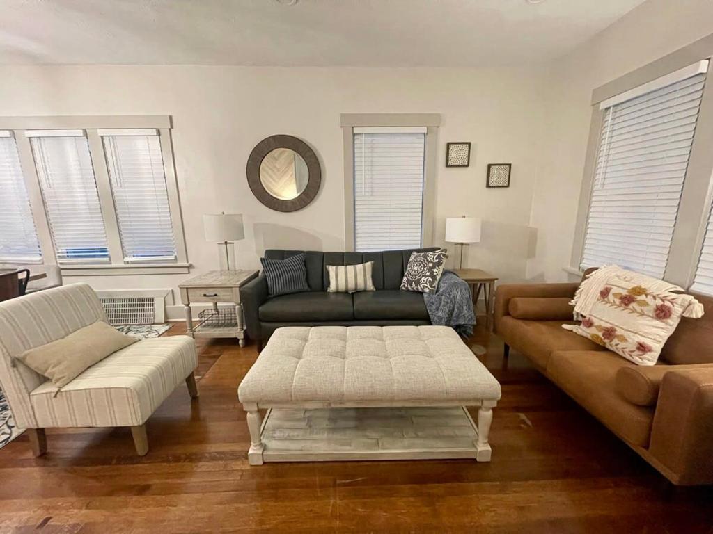 a living room with a couch and a table at The Hamilton House Family Home in Omaha