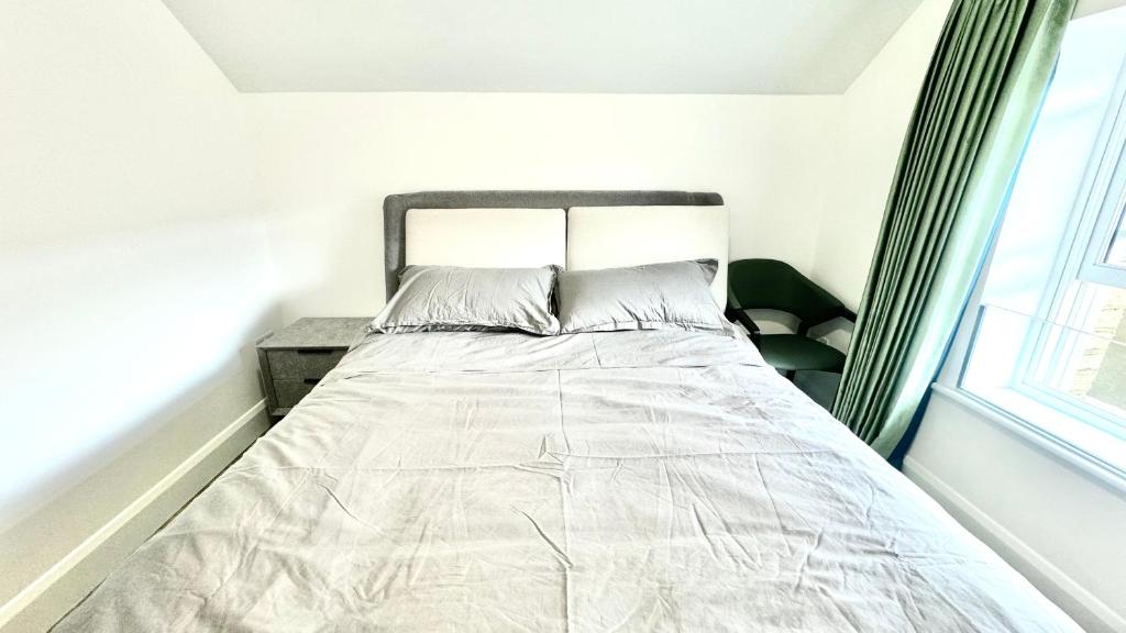 a bed in a white bedroom with a window at Mary St House 3A in Dublin