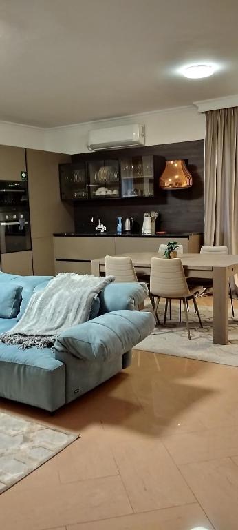 a bedroom with a bed and a table and chairs at Villa Chaplin in Tirana