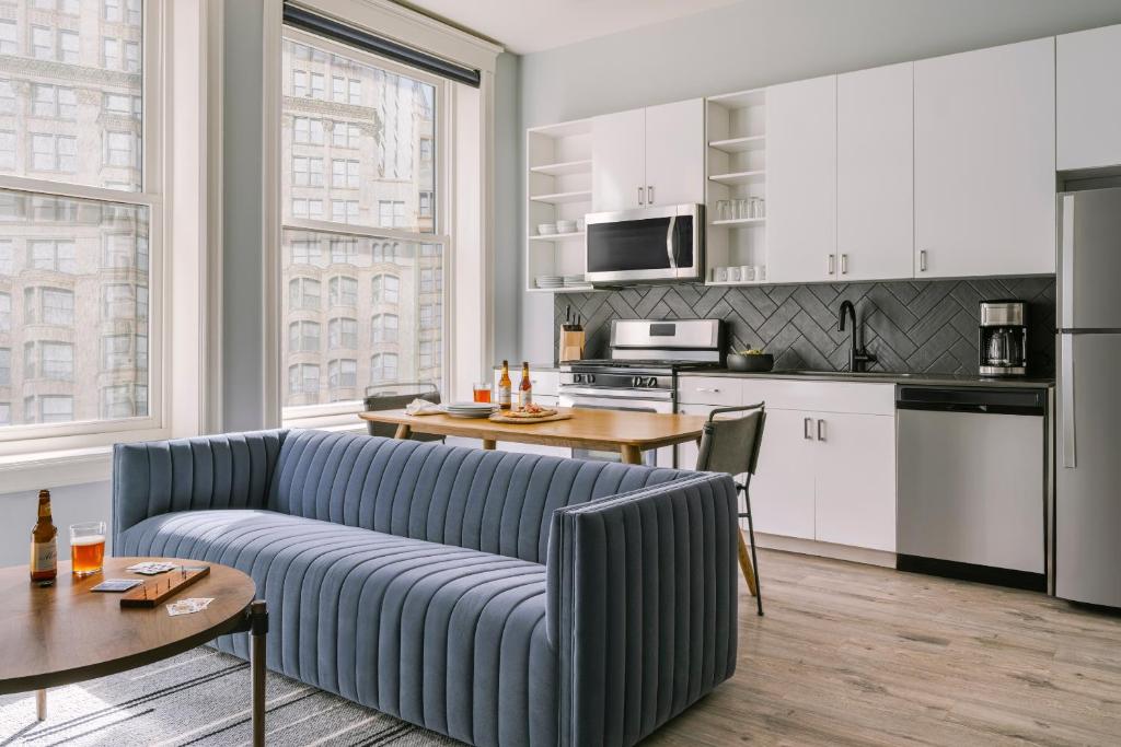 a living room with a couch and a kitchen at Sonder The Plymouth in Chicago