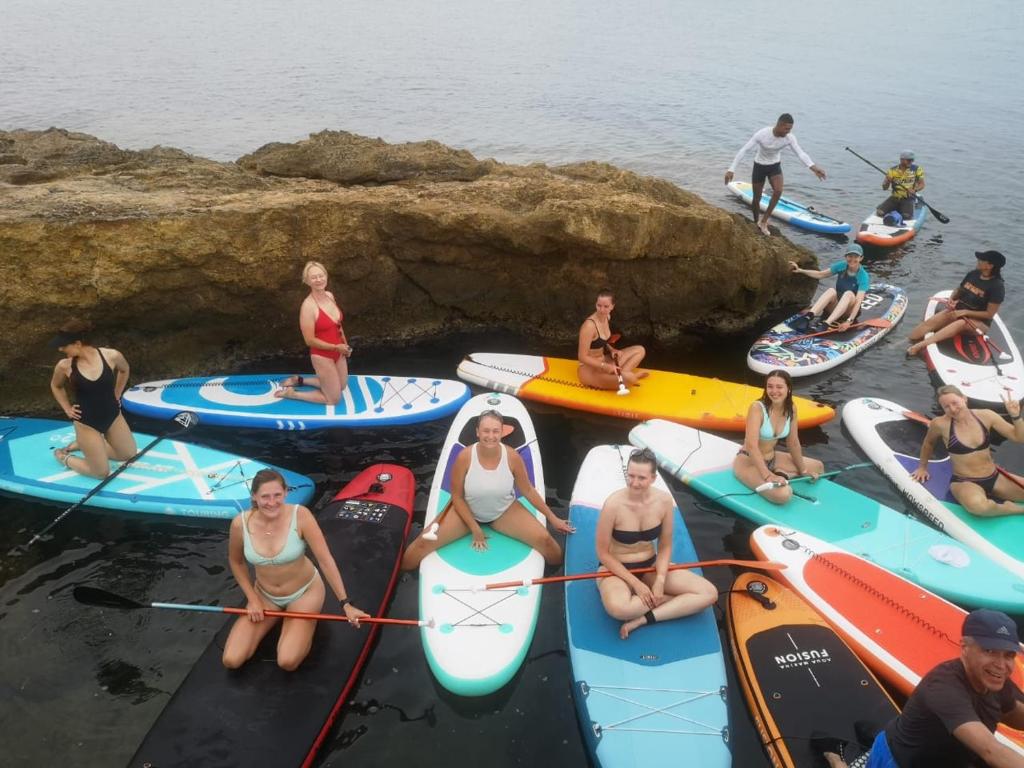 a group of people sitting on kayaks in the water at Dar El Mahdia by Daldoul in Mahdia