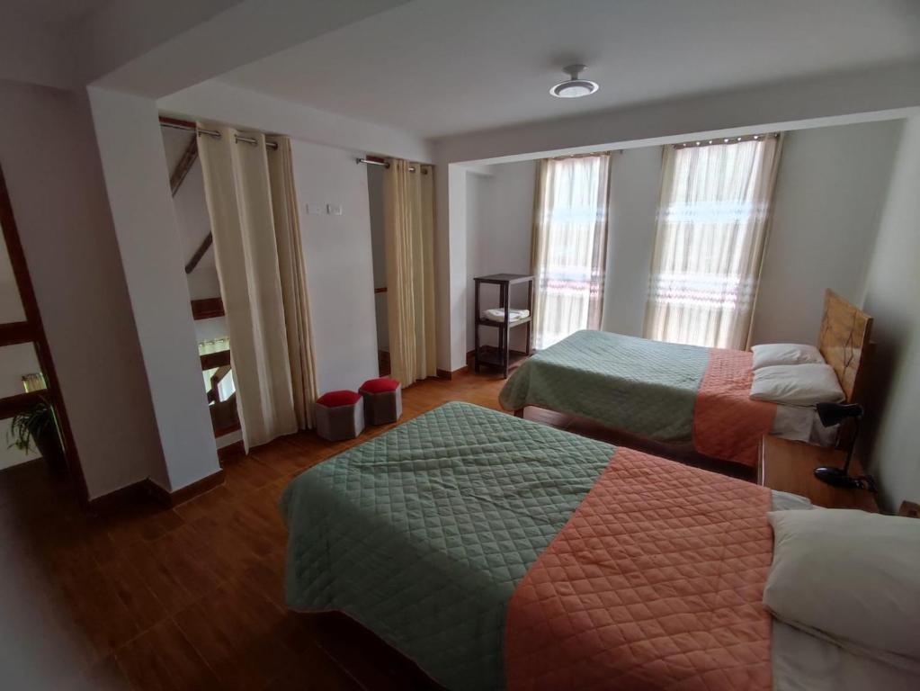a hotel room with two beds and a staircase at casa edad dorada in Cusco