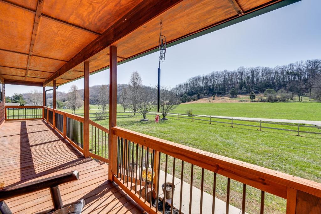 a large deck with a view of a field at Pet-Friendly Countryside Haven Near Cherokee Lake! in Rogersville