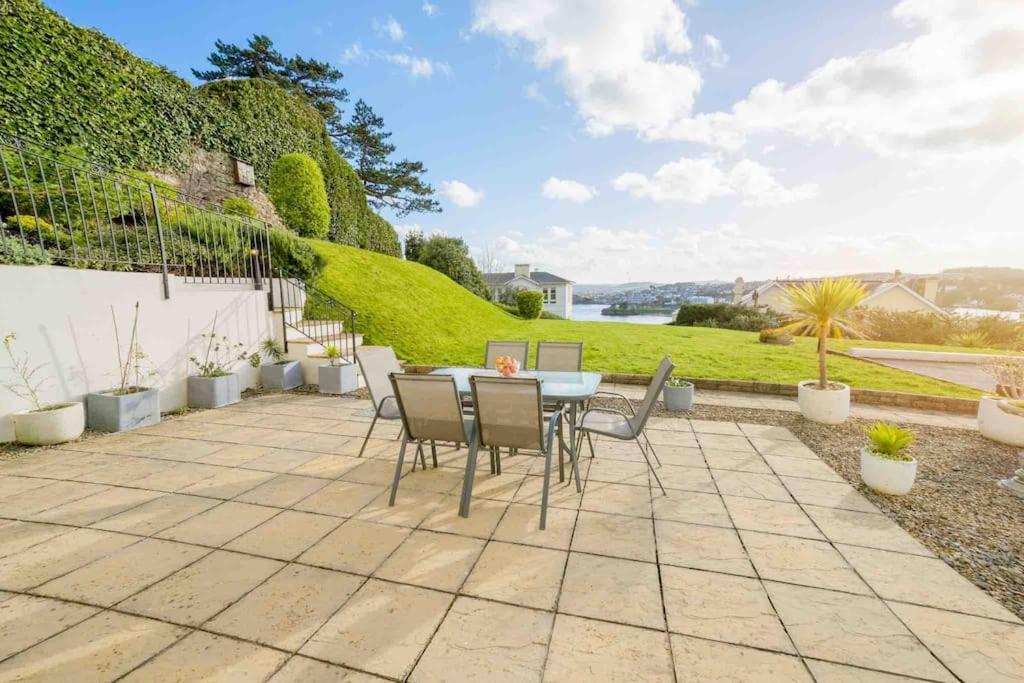 a patio with a table and chairs on a patio at Ground Floor Sea View Apartment Private Terrace in Torquay